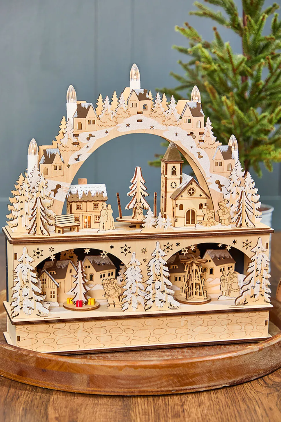 14.75" Lighted Laser Cut Wood Village Scene with Moving Figurine and Candles